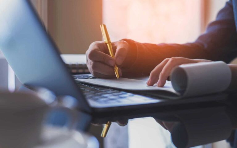 Image of a business person writing a check