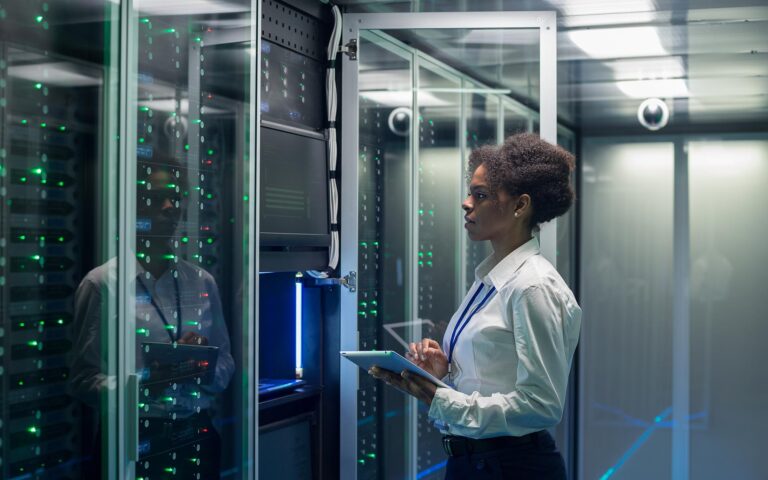 Technician working on computer in data center