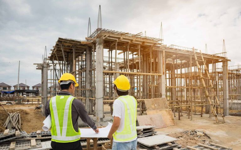 Two construction workers at a construction site