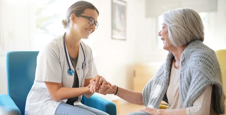 Doctor reassuring older woman in modern clinic