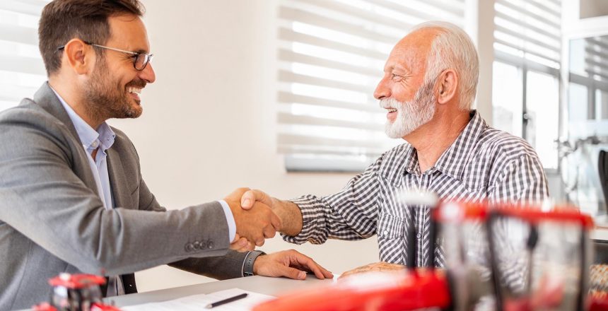 Farmer shaking hands with business person