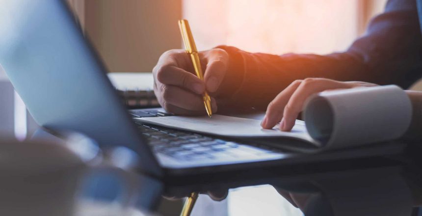 Image of a business person writing a check