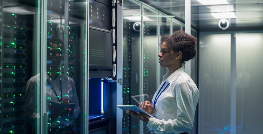 Technician working on computer in data center